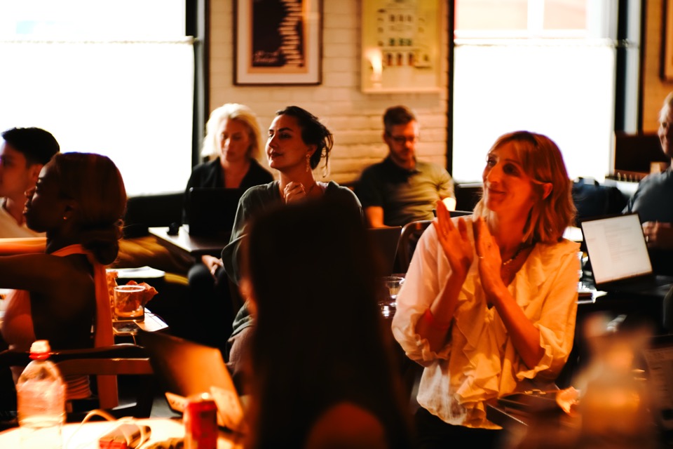 Workshop attendees applauding and smiling at the end of a Light School AI day in London