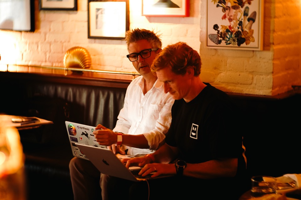 Two attendees building an app together on a laptop at a Light School workshop